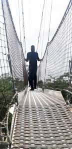 man on a bridge at lekki conservation centre 